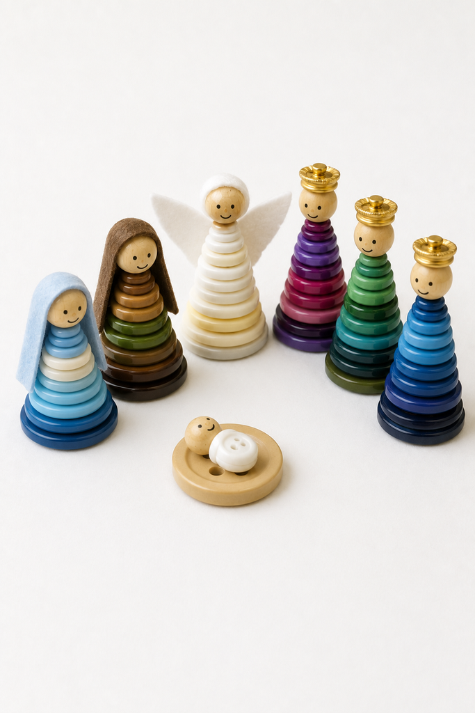 A button nativity of cone-shaped button stacks with wooden-bead heads, including Mary, Joseph, an angel, three kings, and a baby Jesus on a flat button.