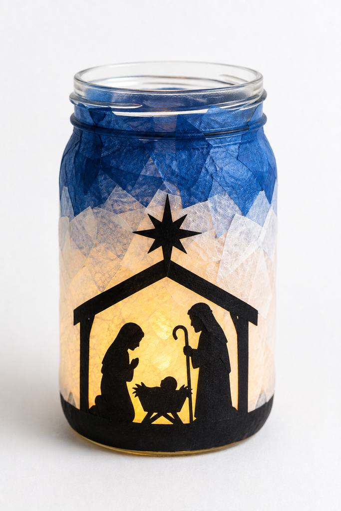 A glass jar with a black nativity silhouette and tissue paper, glowing from a battery light inside.