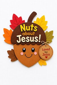 Finished Nuts About Jesus acorn craft with a smiling face, fall leaves, and a "Loved by Jesus" tag