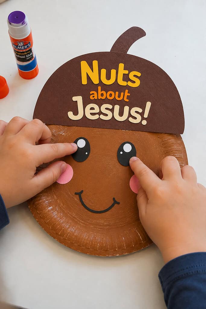 A child adding the eyes, cheeks, and smile to the paper plate for the Nuts About Jesus acorn paper plate craft