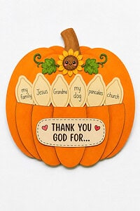 Finished Thanksgiving pumpkin Sunday school craft with a "Thank You God For" sign, a smiling sunflower, and paper pieces fanning out of the top