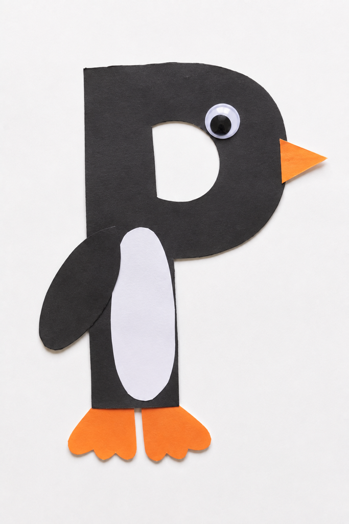 a black letter P penguin craft with a white belly, googly eye, orange beak, and orange feet