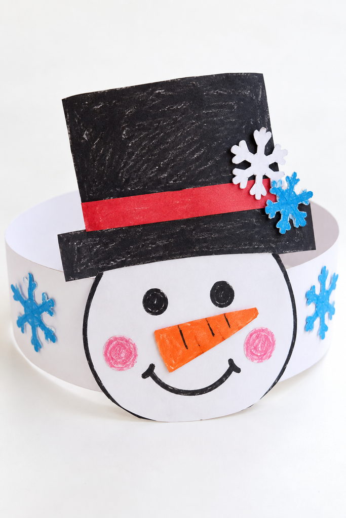 a wearable snowman headband craft with a snowman face, black hat, dot eyes, orange nose, and paper snowflakes on a white table
