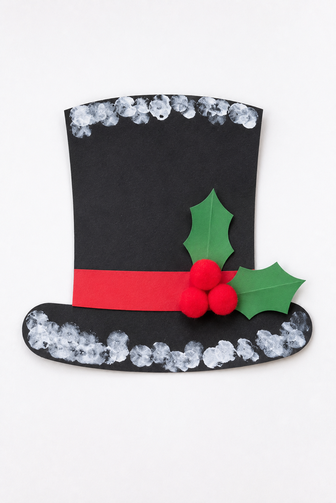 a small black paper top hat with a red band, snow dabs, and a holly sprig