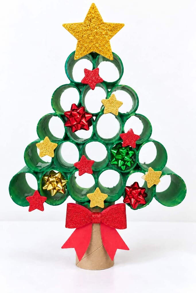 A Christmas tree made of green-painted cardboard tube rings with a gold star and foam decorations.